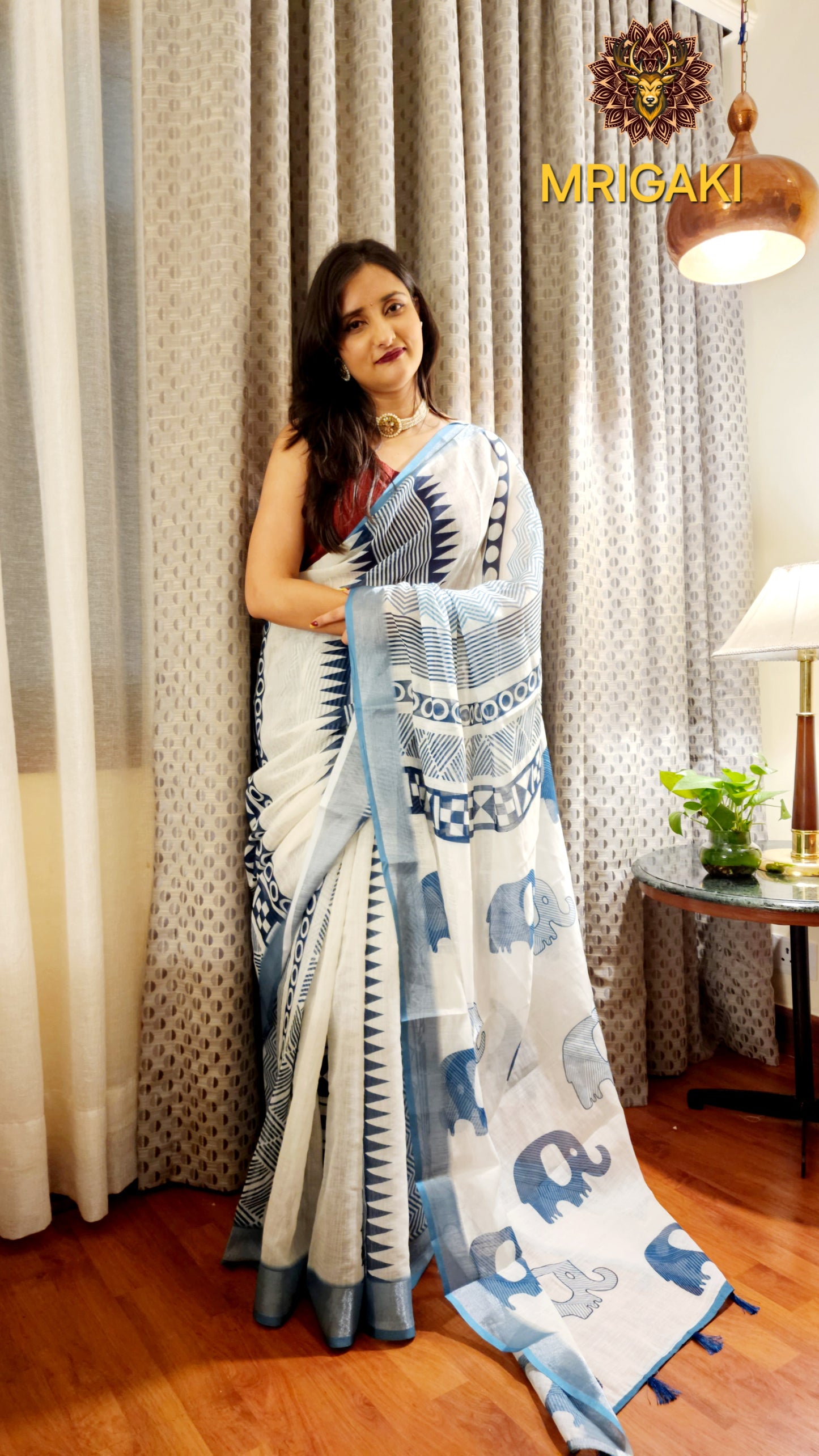 White Base Linen Saree with Geometrical design all over, turquoise blue elephant design border with Pom-Pom on Pallu