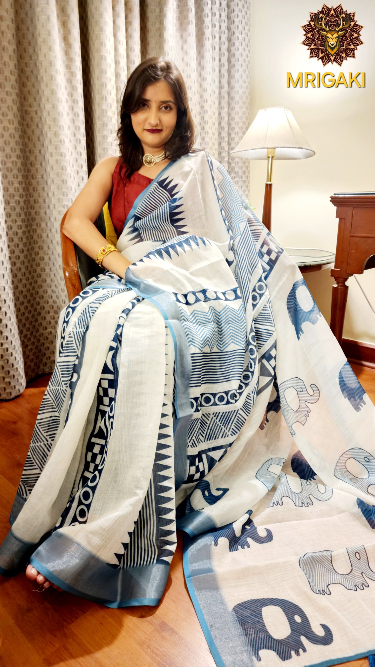 White Base Linen Saree with Geometrical design all over, turquoise blue elephant design border with Pom-Pom on Pallu