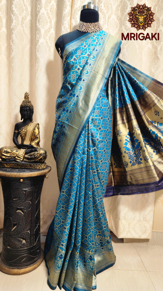 Warm Silk  Saree in Turquoise Blue color with geometrical print all over & Patola Print Pallu
